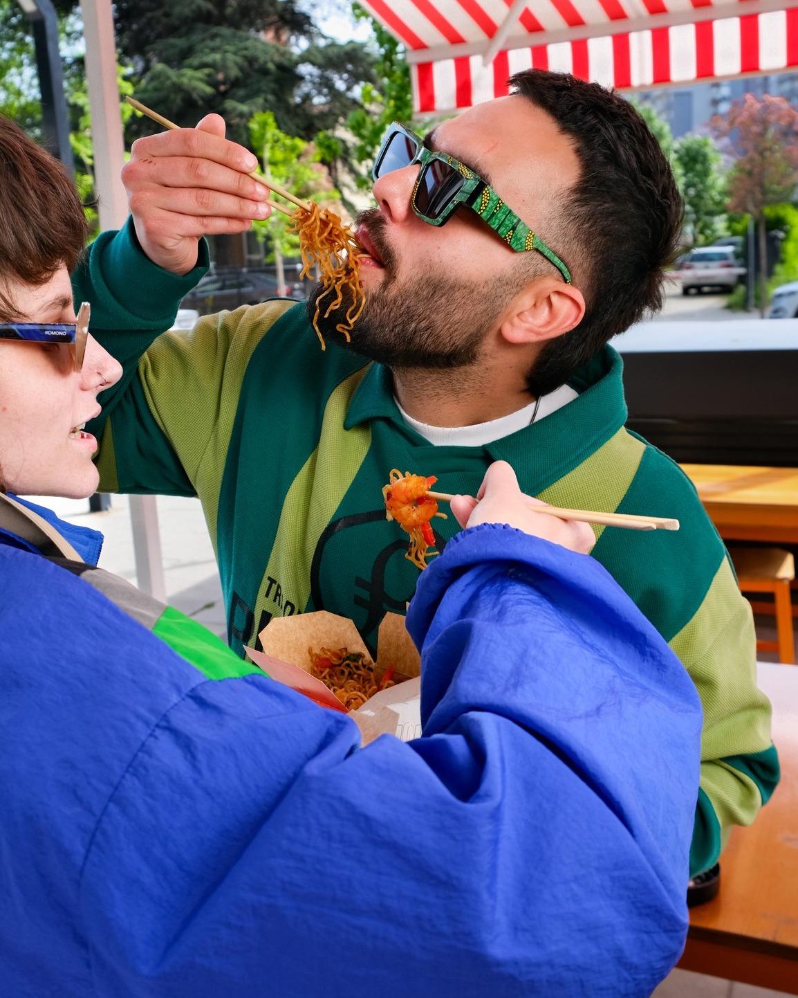 Friends eating WokWok noodles outside